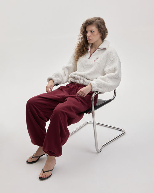 Grown In Silence barrel joggers in Ruby Wine, seated styled look