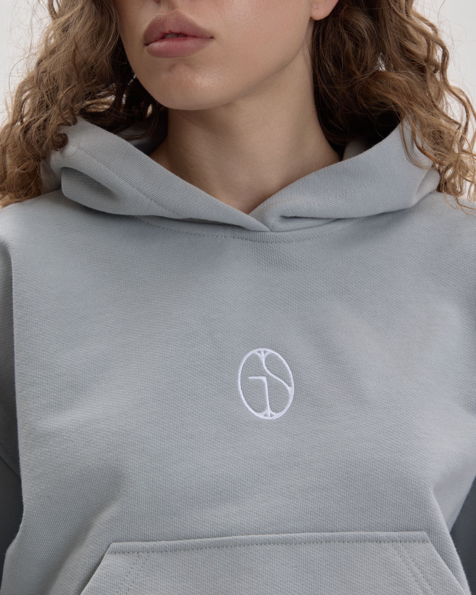 Grown In Silence cropped mini hoodie in Cloud Metallic, embroidered GIS chest logo close-up