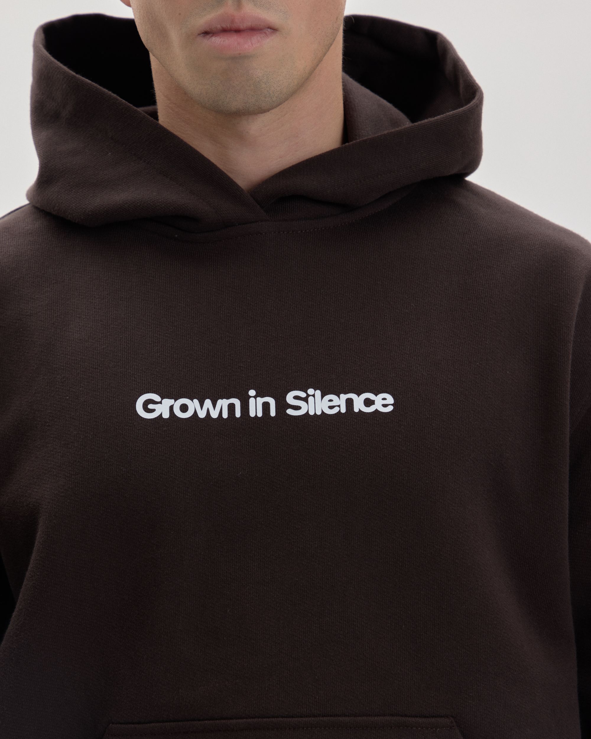 Grown In Silence oversized hoodie in choco brown, front close-up with chest logo
