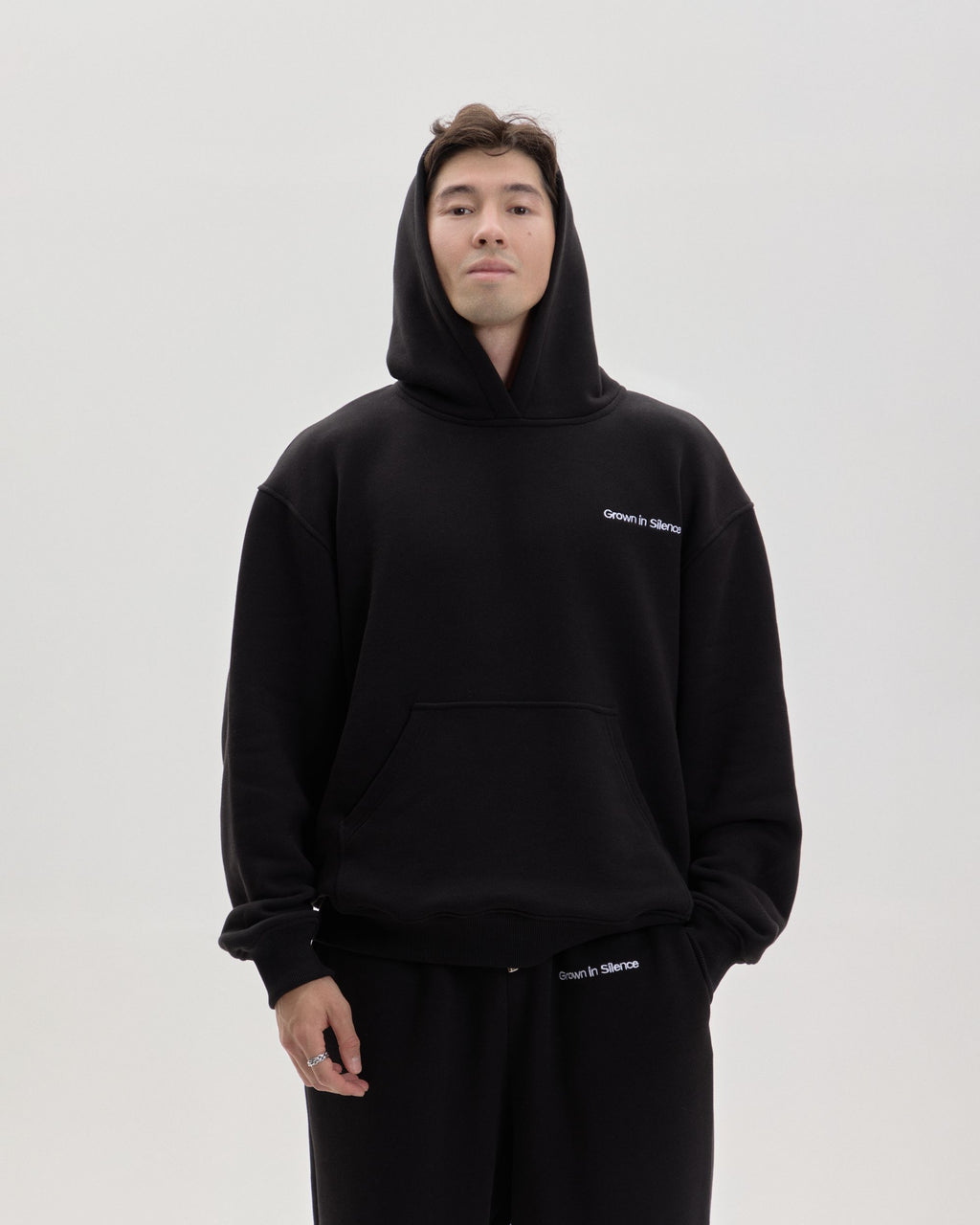 Grown In Silence oversized hoodie in Midnight Black, front view with hood