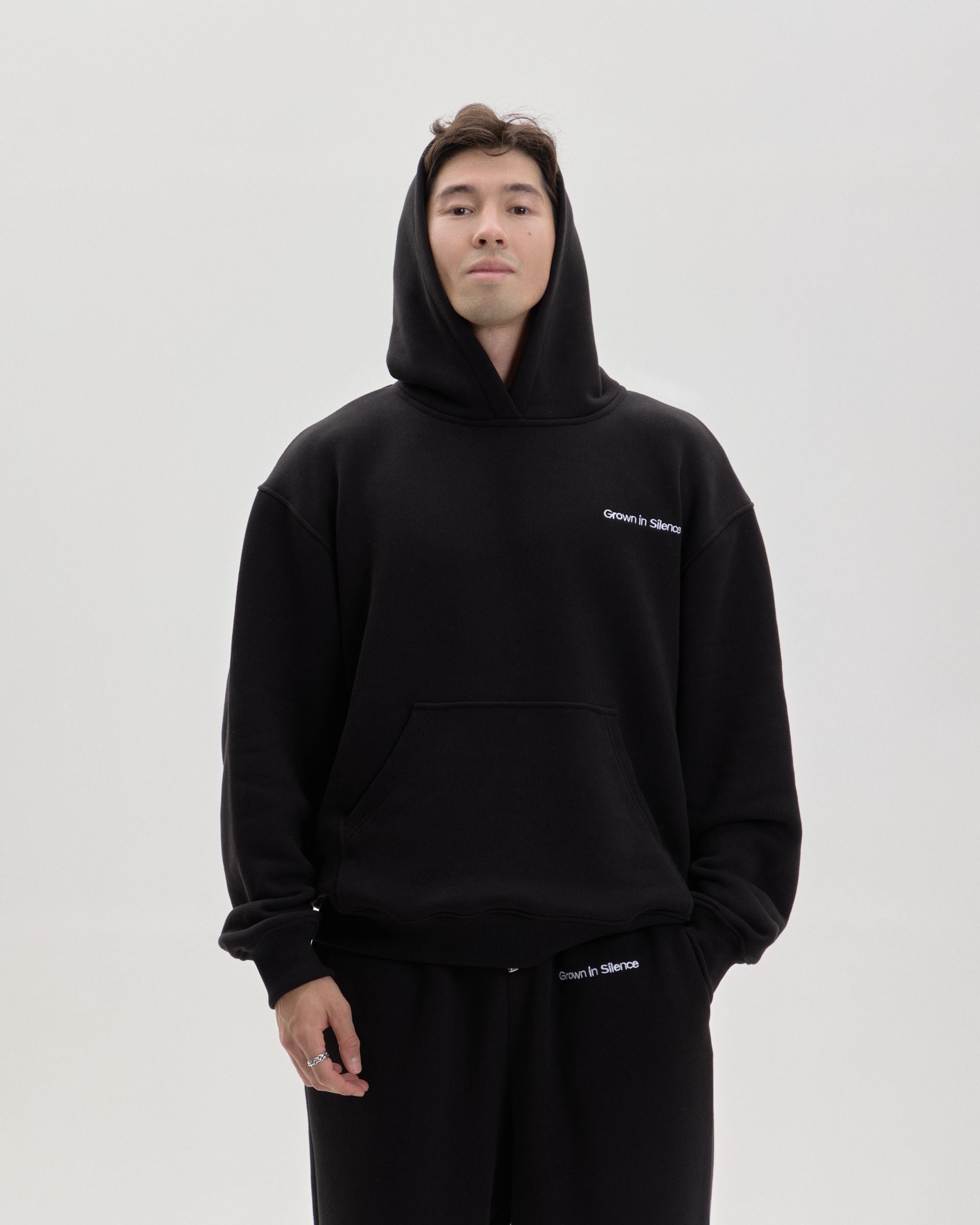 Grown In Silence oversized hoodie in Midnight Black, front view with hood