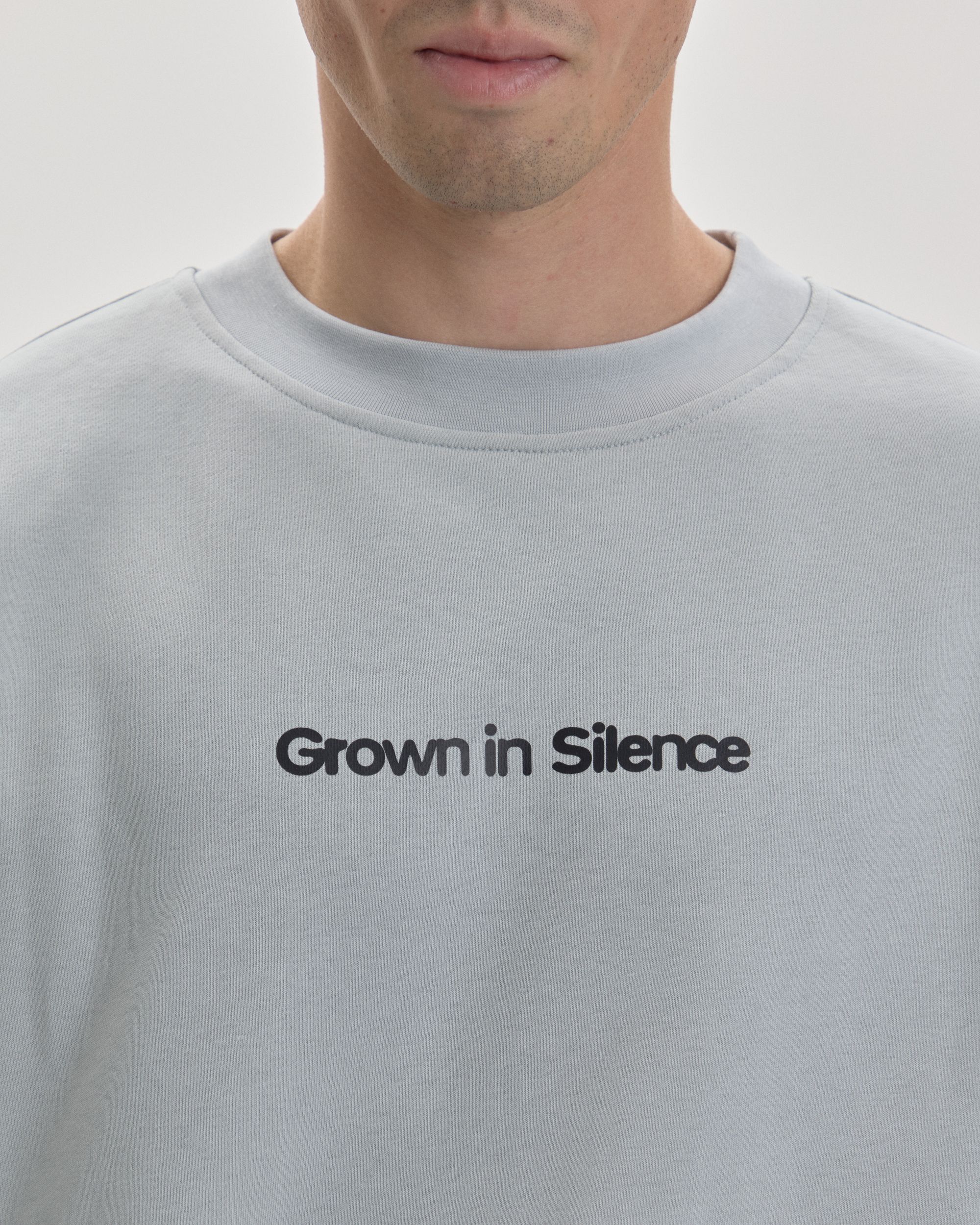 Grown In Silence oversized unisex tee in Cloud Metallic, chest logo detail