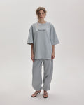 Grown In Silence oversized unisex tee in Cloud Metallic, front view on female model