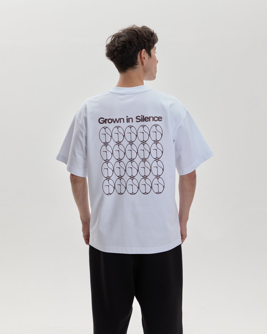 Grown In Silence oversized unisex tee in Raw White, back print on male model