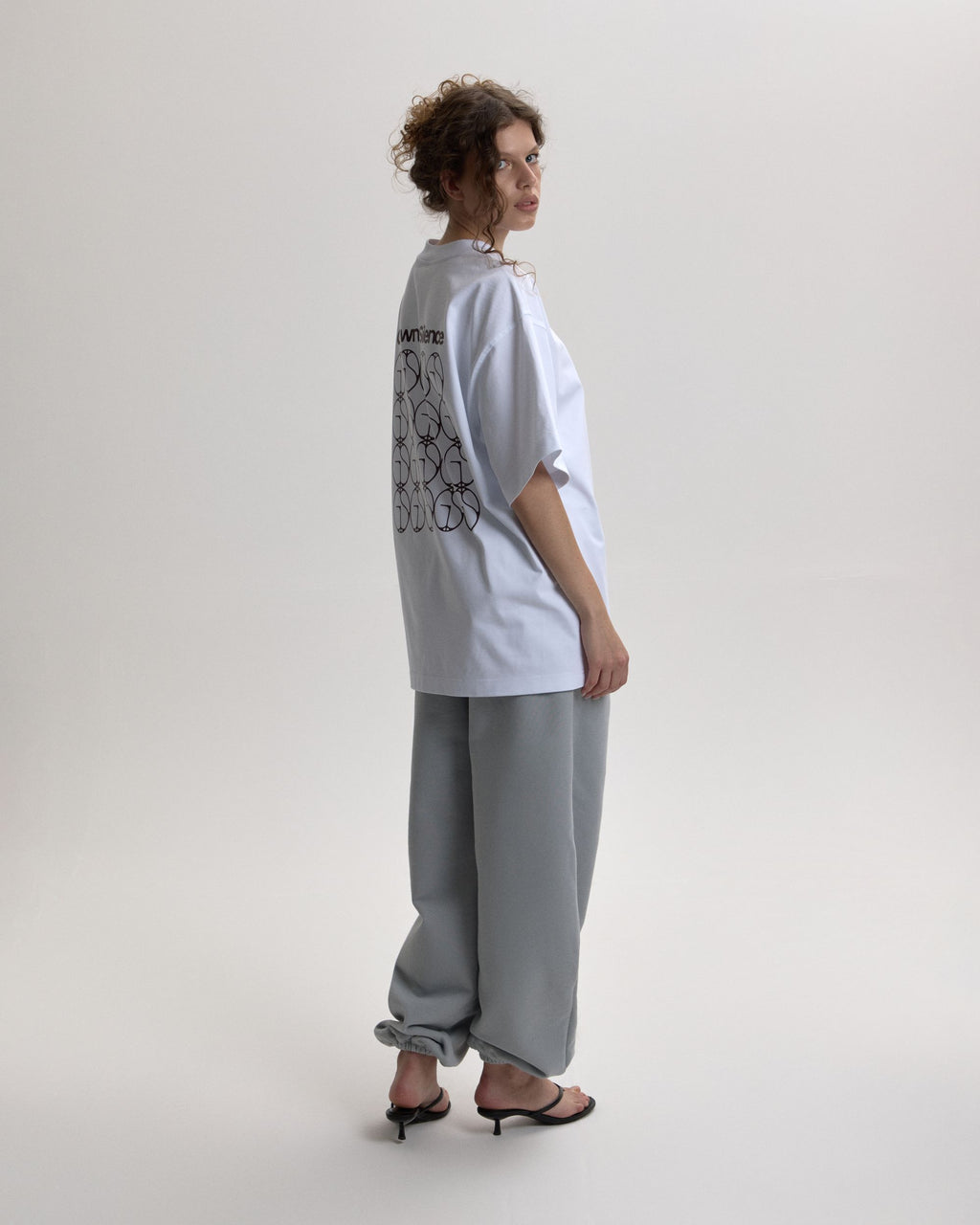 Grown In Silence oversized unisex tee in Raw White, full length styled look